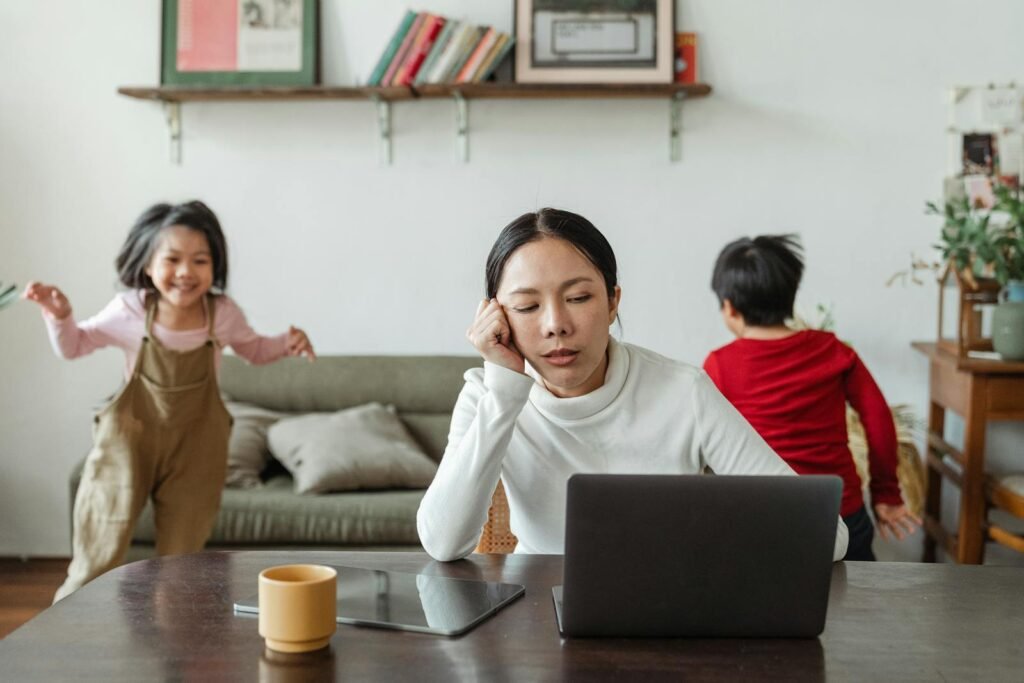 Kids making noise and disturbing mom working at home