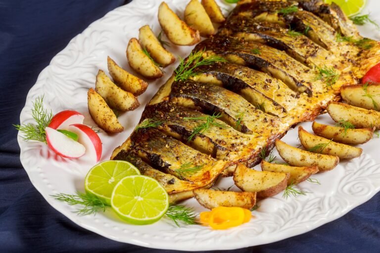 Grilled fish with roasted potatoes and vegetables on the plate
